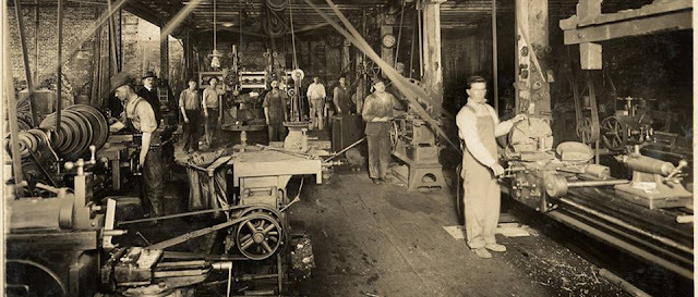 Steam-era factory interior, line shafts and belts